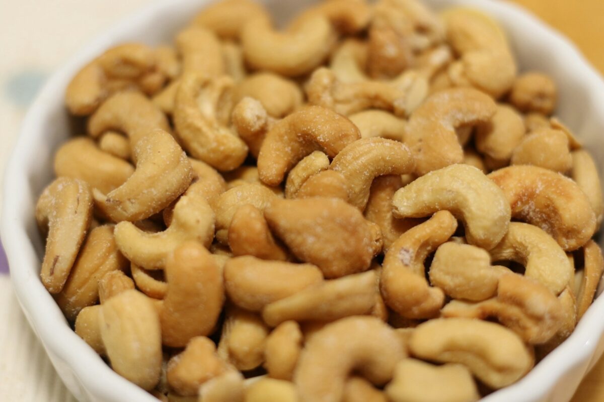 a white bowl filled with cashews on top of a table